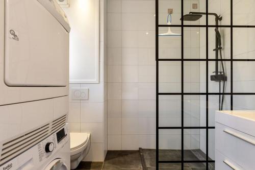 a small bathroom with a shower and a toilet at Nice apartment in the city center Kerkakker 1 in Eindhoven