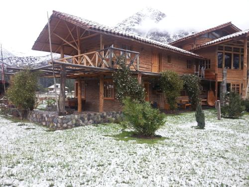 a log cabin with snow on the ground in front of it at La Casa de Carlitos in San José de Maipo