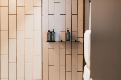 two bottles are sitting on a shelf in a bathroom at Exeter Hotel in Reykjavík