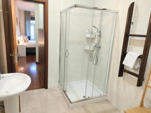 y baño con ducha y lavamanos. en Porto Main Square Penthouse Apartment, en Oporto
