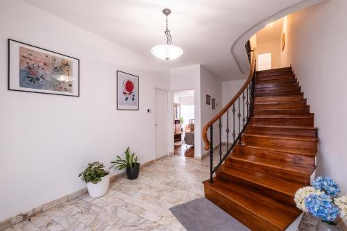 a staircase in a home with white walls at Casa da Nau in Ponta Delgada