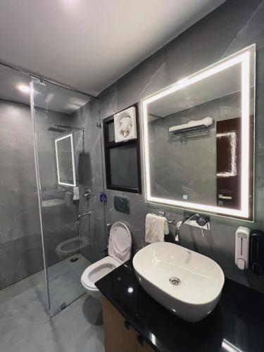 a bathroom with a sink and a toilet and a shower at Samskara & Samsara in Lansdowne