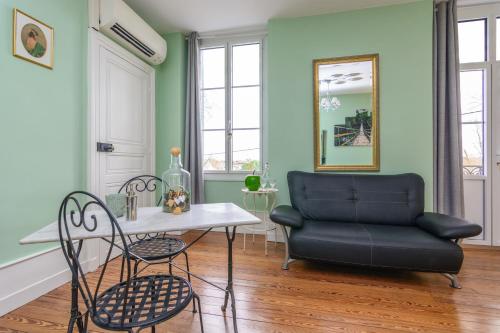 a living room with a table and a couch at Château de la villeneuve in Saint-Marcel