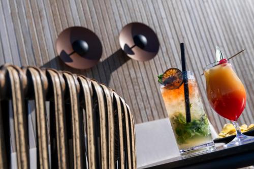 a table with a drink on a table with a chair at Sallés Hotel Pere IV in Barcelona