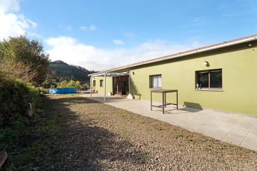 a yellow building with a wooden deck in front of it at Casa Lomo el Aire Aceviño in Tegueste