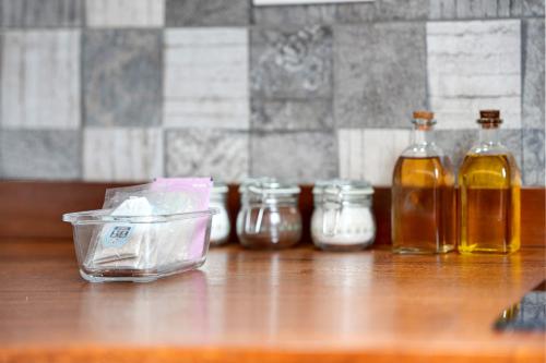 a group of bottles of oils on a wooden table at Casa Lomo el Aire Aceviño in Tegueste