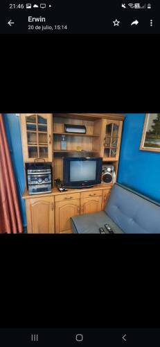 a picture of a room with a tv and a desk at Cabaña cómoda 1 dormitorio in Coihaique
