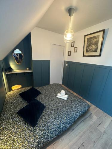 a bedroom with a bed with two pillows at Gîte de charme, Le Terrier in Besse-et-Saint-Anastaise