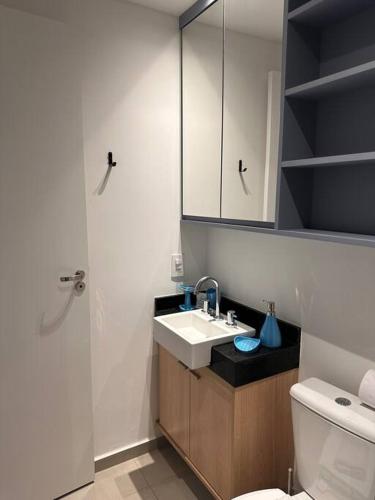 a bathroom with a sink and a toilet and a shower at Estúdio VN Consolação in Sao Paulo