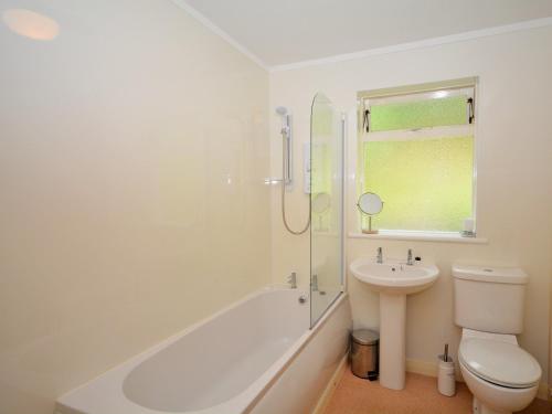 a bathroom with a shower and a sink and a toilet at 2 bed in Lochgilphead AG692 in Tayvallich