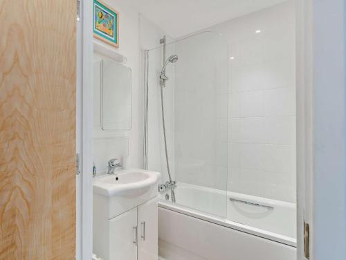 3 Bed in Appledore 28479 في آبيلدوور: حمام أبيض مع حوض وحوض استحمام