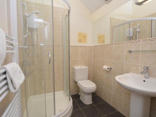 a bathroom with a shower and a toilet and a sink at 2 bed property in Shaftesbury 28678 in Sedghill