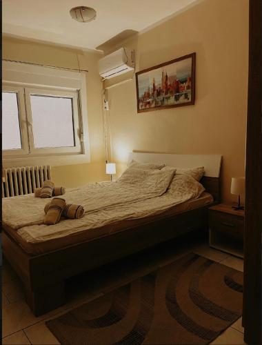 a bedroom with a bed with two pillows on it at Kristina NS in Novi Sad