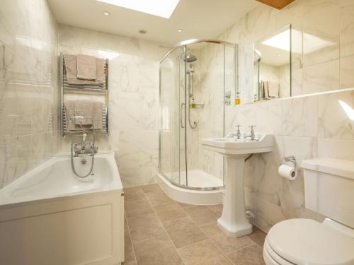a bathroom with a shower toilet and a sink at 4 Bed in Dorchester 42204 in Frampton