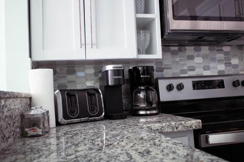 a kitchen with a counter top with a coffee maker at SEAFLECTIONS in Kingston