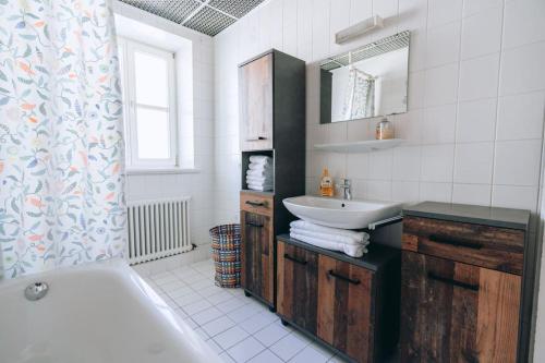a bathroom with a tub and a sink and a bath tub at Große 4-Zimmer-Wohnung in der Ingolstädter City. in Ingolstadt
