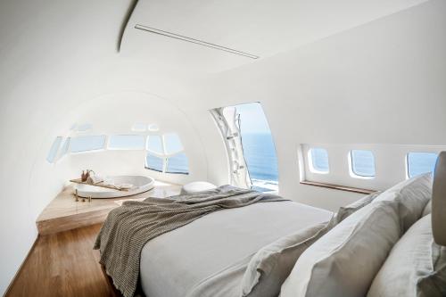a bedroom with a bed and a sink in a plane at Private Jet Villa Uluwatu in Uluwatu