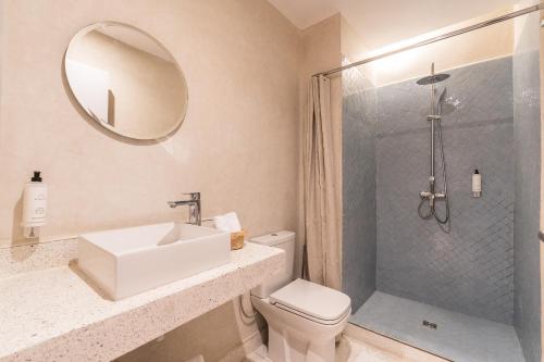 a bathroom with a toilet and a sink and a shower at JEMAA EL FNA Suites & Spa in Marrakech