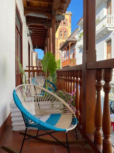 a balcony with two chairs on a porch at Hotel Casa Agustina in Cartagena de Indias