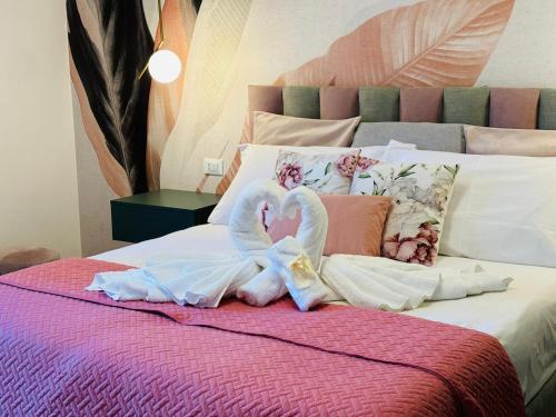 a bed with swans made out of towels on it at Sant'Orsola Lodge Bologna in Bologna