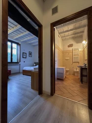 a room with a bed and a bathroom with a mirror at Appartamento in storica Cascina Lombarda Cusago Rho-Fiera-San-Siro in Cusago