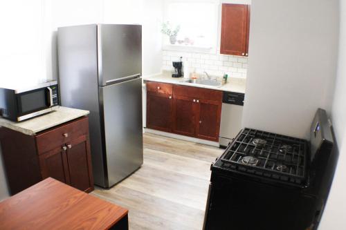 a kitchen with a refrigerator and a stove at 2BR - Parking - 5 Min to North Shore! in Pittsburgh