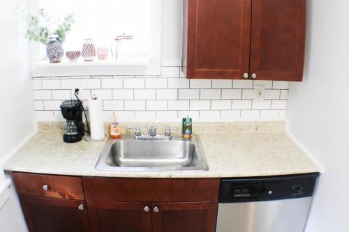 a kitchen counter with a sink and a dishwasher at 2BR - Parking - 5 Min to North Shore! in Pittsburgh