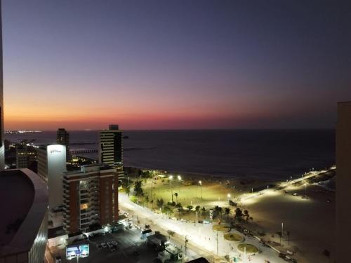 a view of a city at night with the ocean at Ocean Atlantic Praia de Iracema in Fortaleza