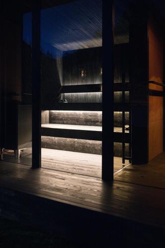 a view from a dark room with a window at DOLOMITI EXCLUSIVE YOUR MOUNTAIN SUITE in Pozza di Fassa