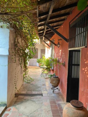 an outside hallway of a house with a courtyard at CASA SINNING-año1637 in Mompos