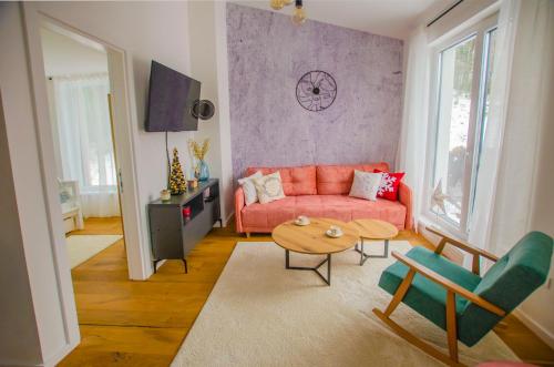 別拉什尼察的住宿－Bjelasnica view lodge，客厅配有红色的沙发和桌子