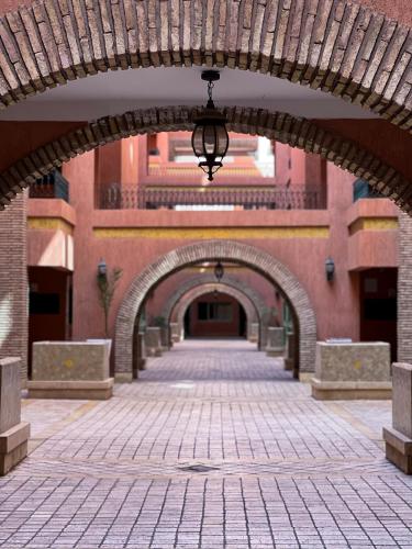 an archway in a brick building with an arcade at Peaceful Apartment: Hivernage,Guéliz in Marrakesh