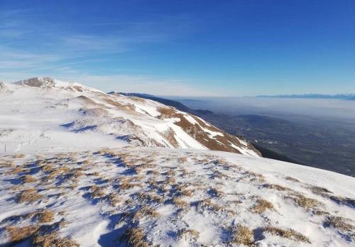 a snow covered mountain with a view of the ocean at Nice and cosy flat near Geneva or Annecy in Bellegarde-sur-Valserine