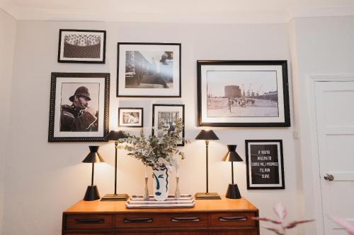 um quarto com uma mesa com quadros na parede em Hoole House em Chester