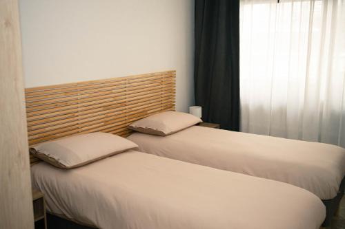 two beds sitting next to each other in a room at Black Marble - Design Apartment in Bari