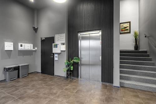 a lobby with a staircase and a door and a stair case at Hotel Vellir in Hafnarfjördur