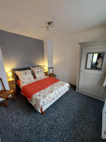 a bedroom with a bed and a window and a door at Gite en pleine verdure au coeur du village in Lapoutroie