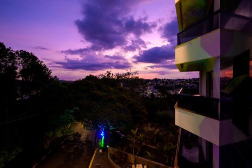 a view of a city at night with a building at Rovi Plaza Hotel in Serra Negra