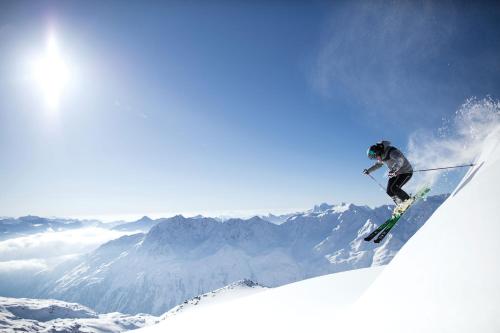 a person on skis jumping off of a mountain at Aktivhotel Waldhof in Oetz