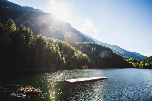 a group of people in a boat on a lake at Aktivhotel Waldhof in Oetz