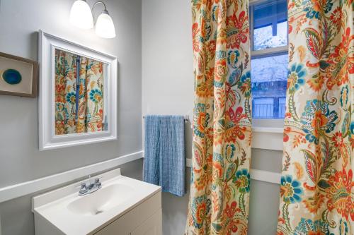 a bathroom with a sink and a window at Charming Home 2 Mi to Downtown Memphis and Zoo in Memphis