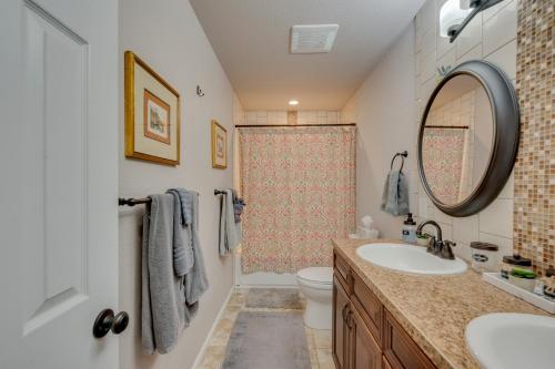 a bathroom with a sink and a toilet and a mirror at Loveland Home with Private Hot Tub and Wood Fireplace! in Loveland