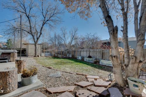 a backyard with a fence and a tree at Loveland Home with Private Hot Tub and Wood Fireplace! in Loveland