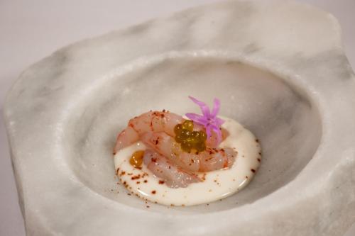 a piece of food sitting on a white plate at AR Diamante Beach & SPA Hotel 4 SUP in Calpe