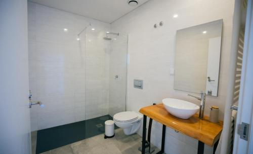 a bathroom with a sink and a toilet and a shower at Lapoint Surf Camp Ericeira in Ericeira