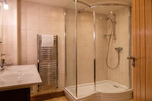 a bathroom with a shower and a sink at Vantage Point, Hillfield Village in Dartmouth