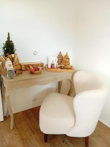 a white desk with a chair and christmas decorations at Domaine du D-DAY in Saint-Côme-du-Mont
