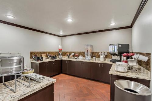 a large kitchen with brown cabinets and a counter top at Park Inn by Radisson, Salt Lake City-Midvale in Midvale