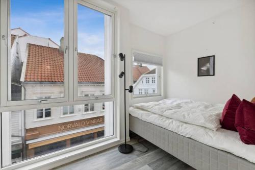 a bedroom with a bed and a large window at Leilighet i Stavanger in Stavanger