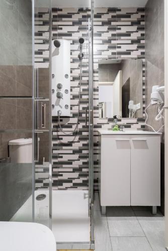 a bathroom with a shower and a white sink at Moreira Family in Porto